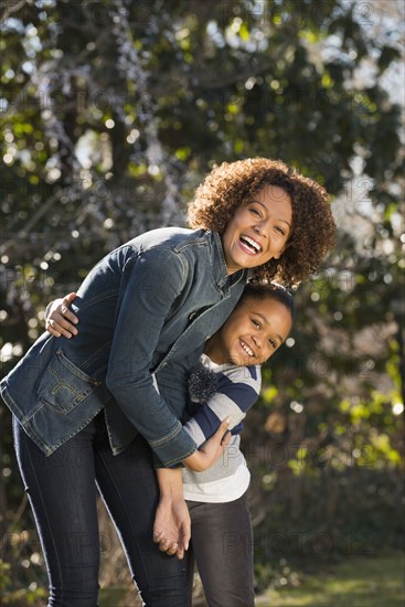 Mother and daughter smiling outdoors