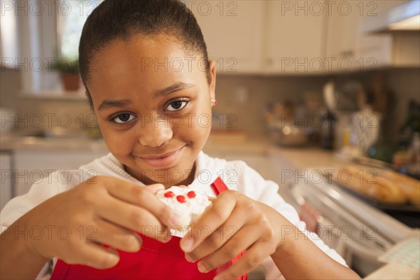 African American girl baking in kitchen