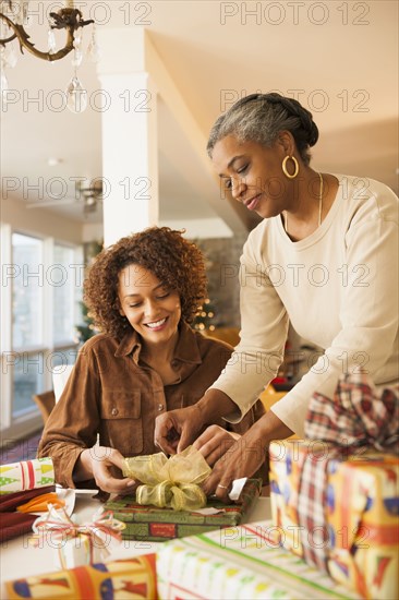 Mother and daughter wrapping Christmas presents