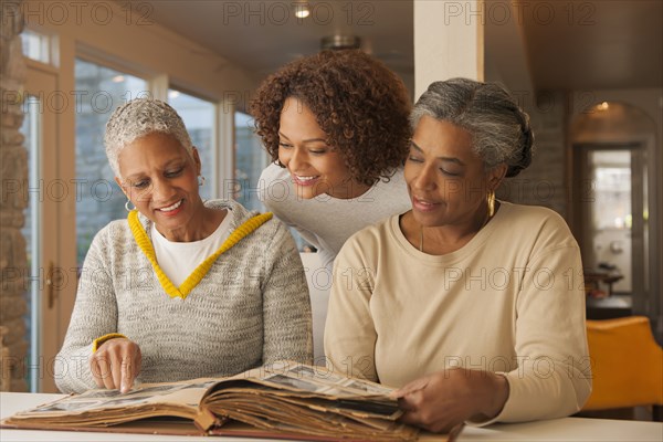 Women looking at family photo album