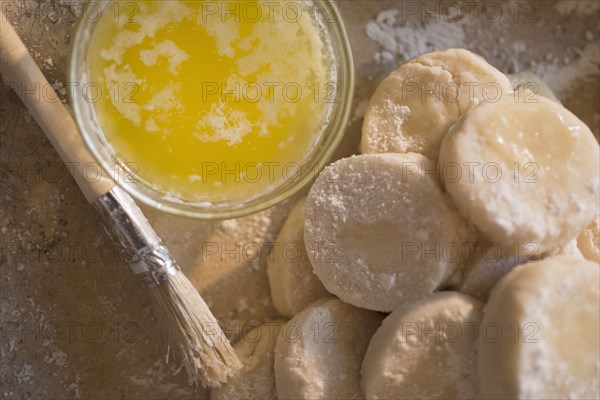 Close up of biscuit rounds and butter