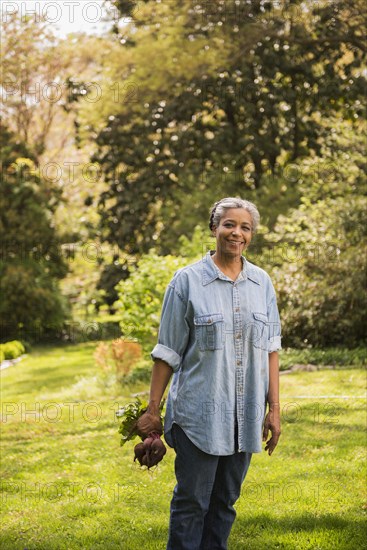 Mixed race woman gardening outdoors