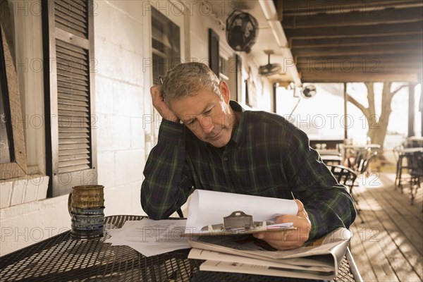 Caucasian businessman working on patio