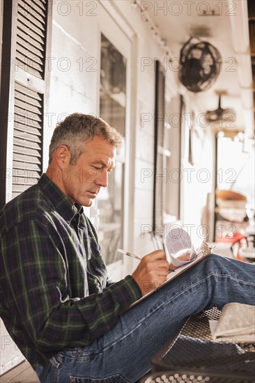 Caucasian businessman working on patio