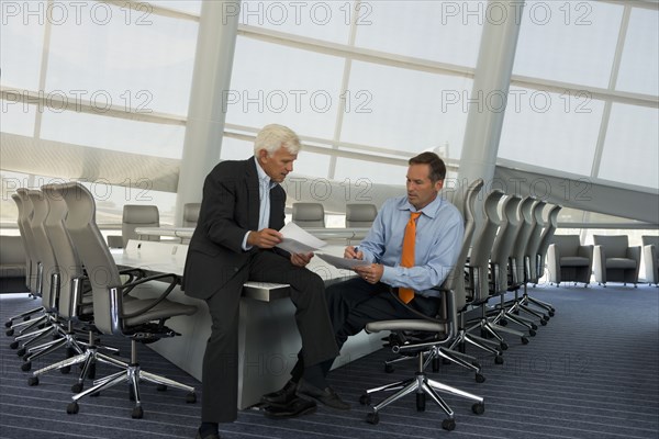 Caucasian businessmen talking in conference room