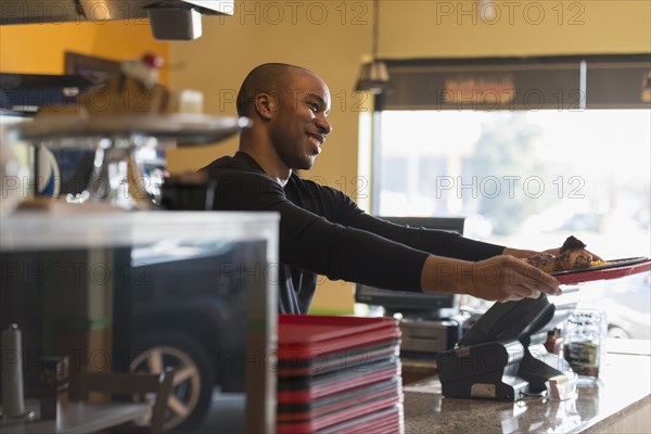 Black server working in cafe