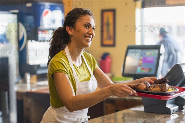 Hispanic server working in cafe