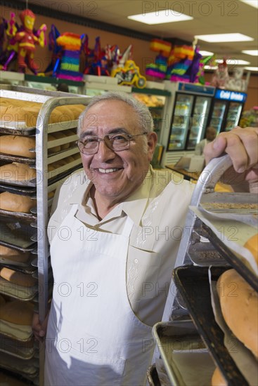 Hispanic baker working in commercial kitchen