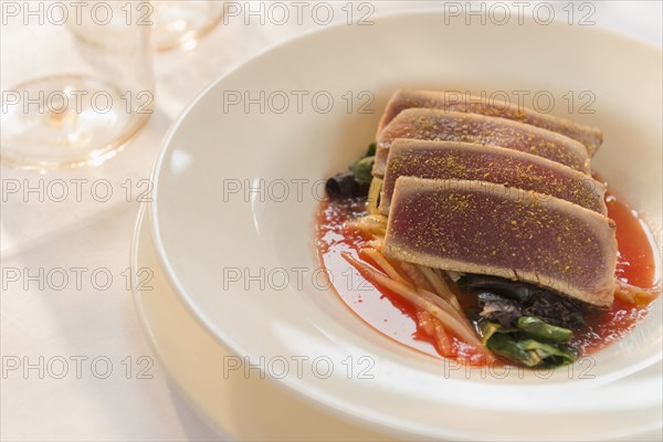 Plate of sliced meat with vegetables