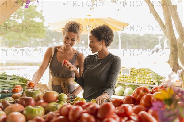 Women browsing produce at farmers market