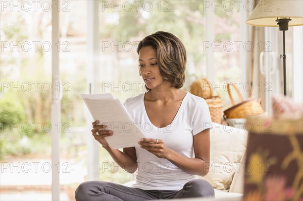 African American woman reading paperwork