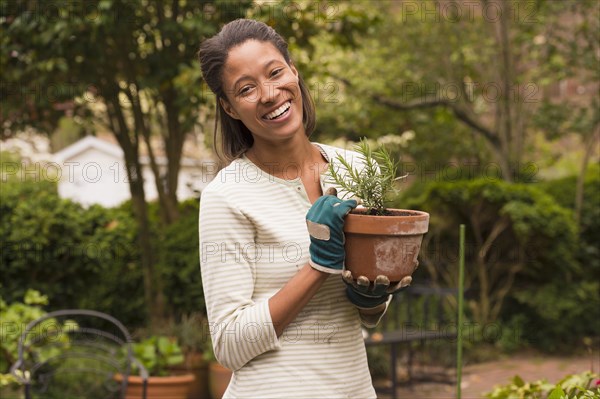 African American woman gardening in backyard