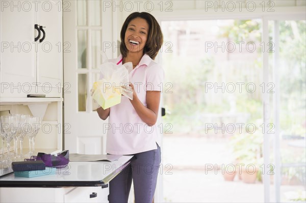 African American woman wrapping gift