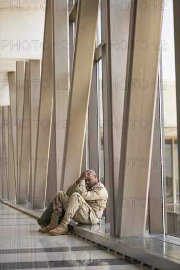 African American soldier sitting in airport