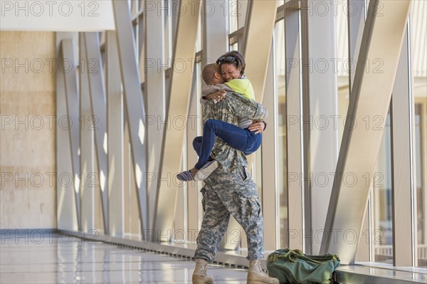 Returning soldier greeting girlfriend in airport