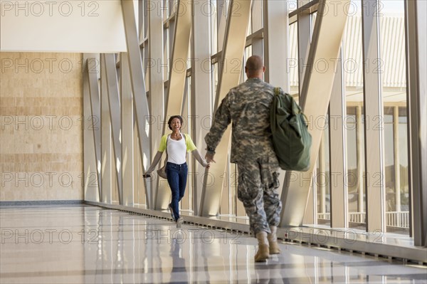 Returning soldier greeting girlfriend in airport