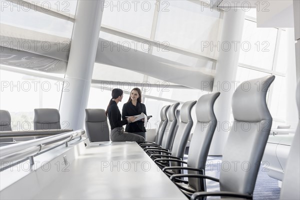 Caucasian businesswomen talking in conference room