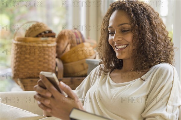 African American woman texting on cell phone
