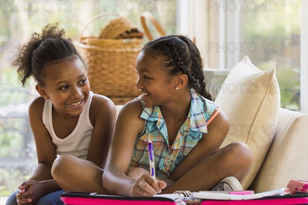 Portrait of smiling girls doing homework