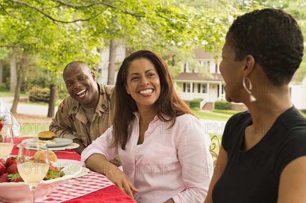 African American man and women laughing at picnic