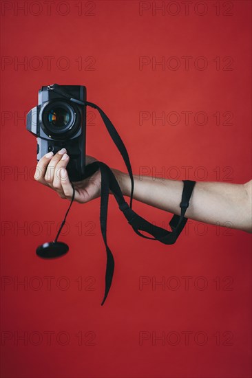 Hand of woman holding camera