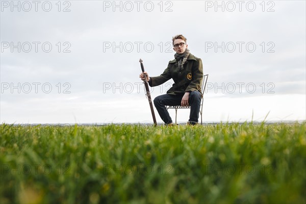 Caucasian man with sword in field