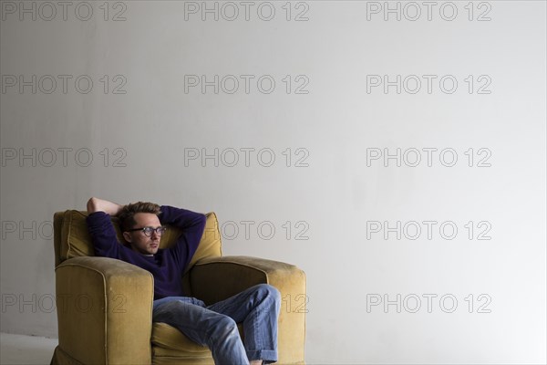 Caucasian man sitting in armchair