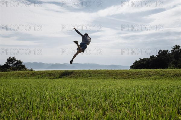 Caucasian man dancing in field