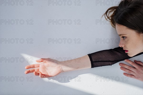 Serious Caucasian woman reaching for light