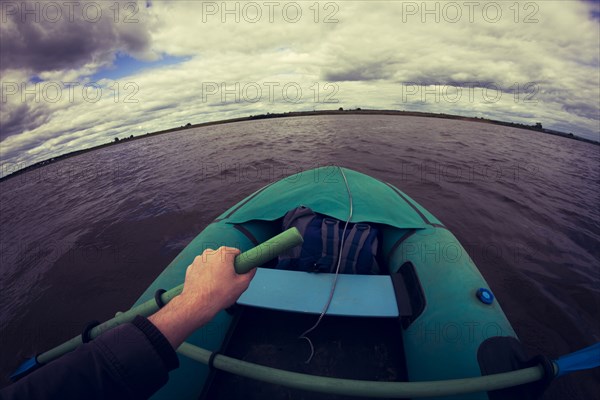 Caucasian girl rowing canoe on lake