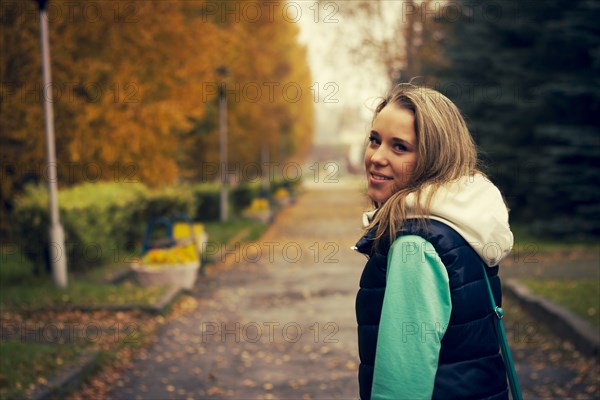 Caucasian woman walking on neighborhood street