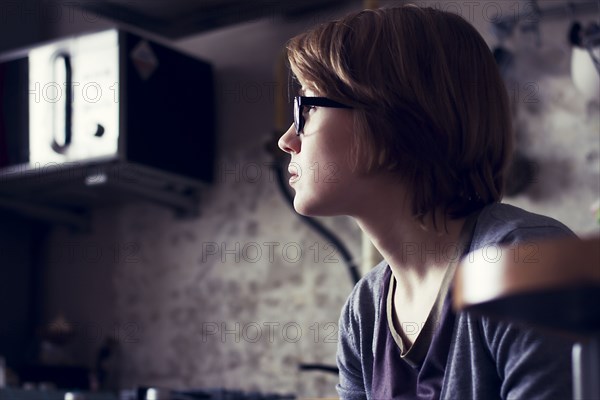 Caucasian woman sitting in kitchen