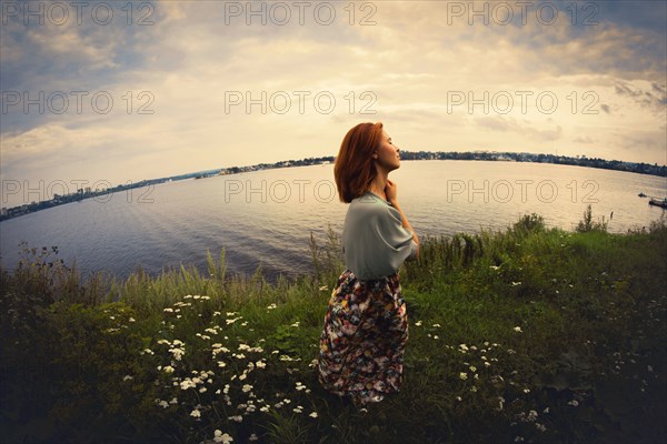 Caucasian woman walking near lake