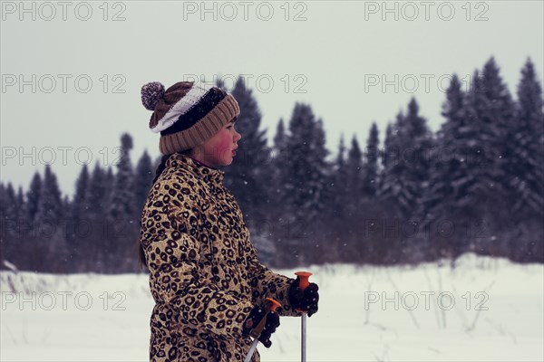 Caucasian boy cross-country skiing in snowy landscape