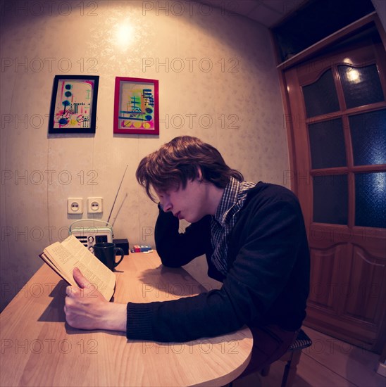 Caucasian man reading at table