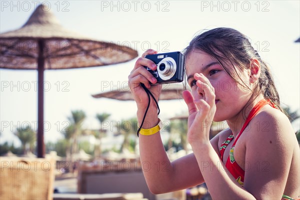 Caucasian girl photographing outdoors