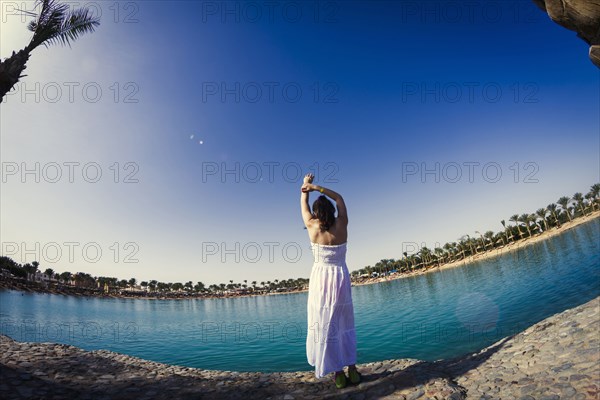 Caucasian girl standing at lake