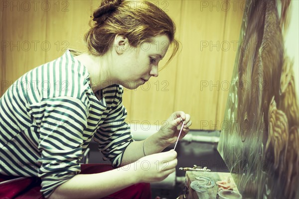 Artist working on painting in studio