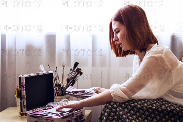 Caucasian woman looking through memory box