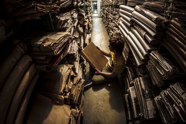 Caucasian man reading book in library archive