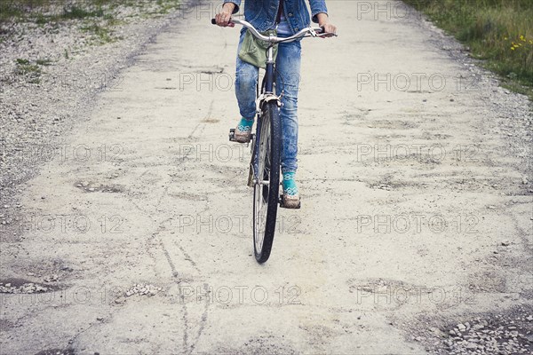 Caucasian teenage girl riding bicycle