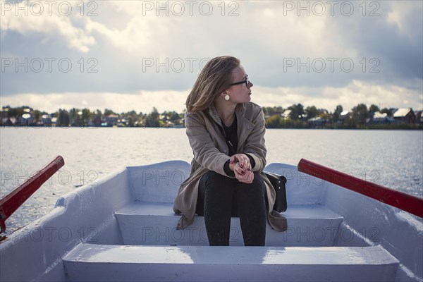 Caucasian woman sitting in rowboat