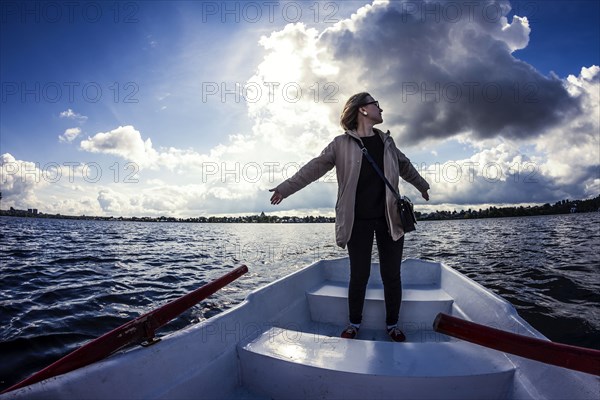 Caucasian woman standing on rowboat