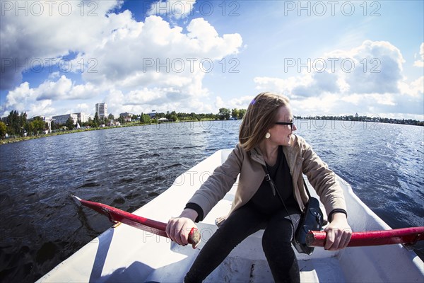 Caucasian woman rowing boat