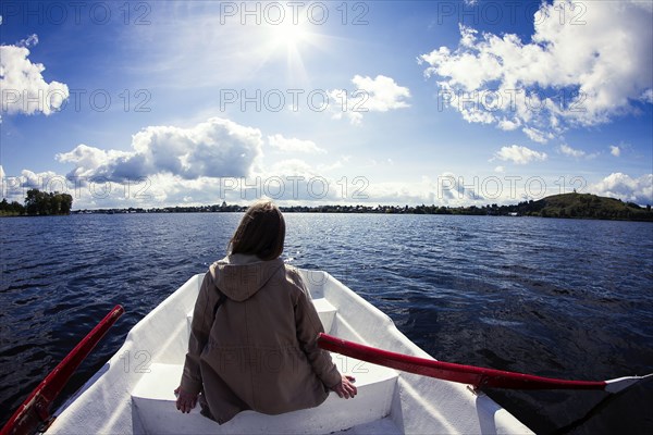 Caucasian woman sitting in rowboat
