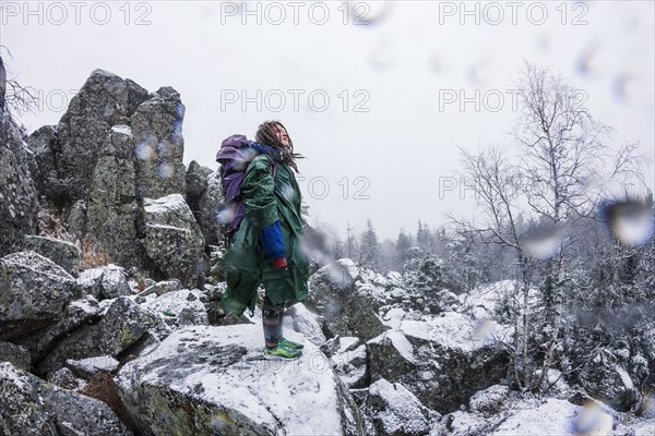 Caucasian hiker standing on rocky hillside