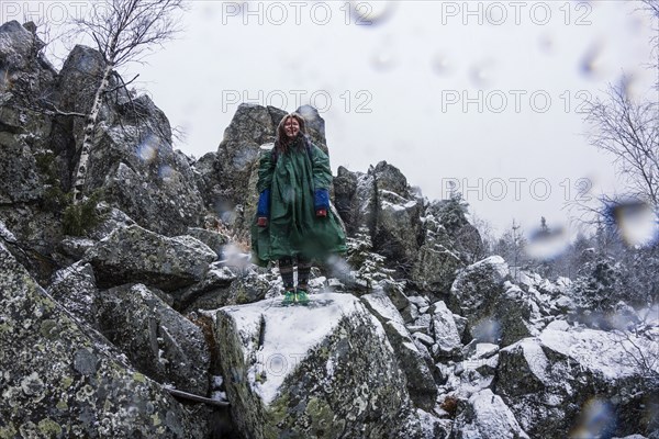 Caucasian hiker standing on rocky hillside