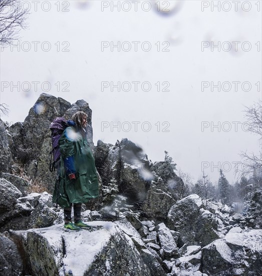 Caucasian hiker standing on rocky hillside