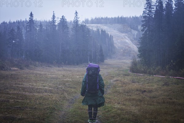 Caucasian hiker standing on remote road