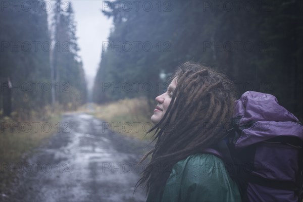 Caucasian hiker smiling on remote road